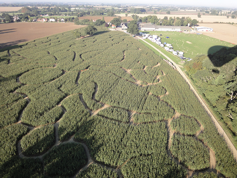 Every year Blake House Craft Centre grows a field of maize and in late summer it is tall enough to be cut to create a maze for visitors to walk in. There have been some great designs over the years and here are just a few that we have snapped on our Essex balloon rides from Blake House over the years.